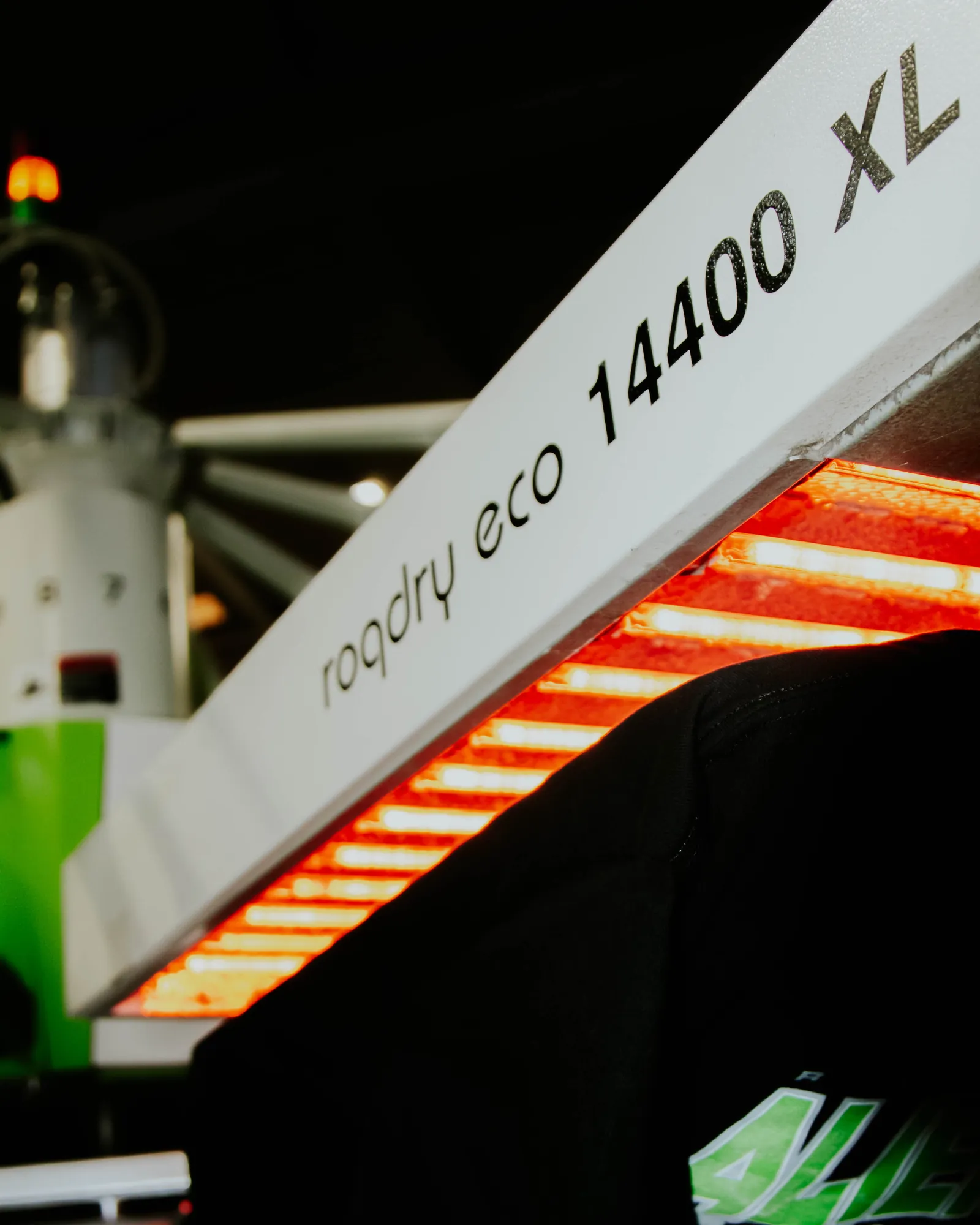 ROQ conveyor dryer glowing red as freshly screen printed shirts cure