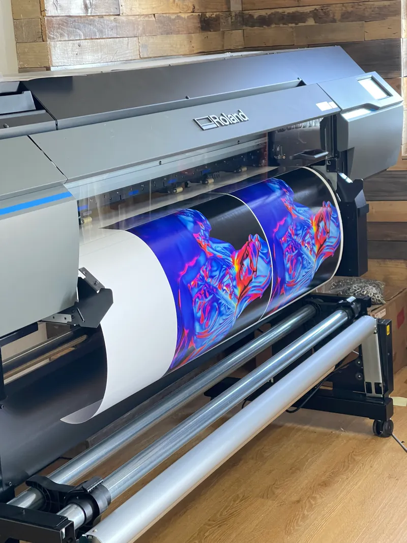 Roland wide-format printer producing vivid custom sticker graphics